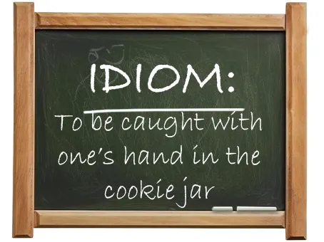 english idiom to be caught with one’s hand in the cookie jar